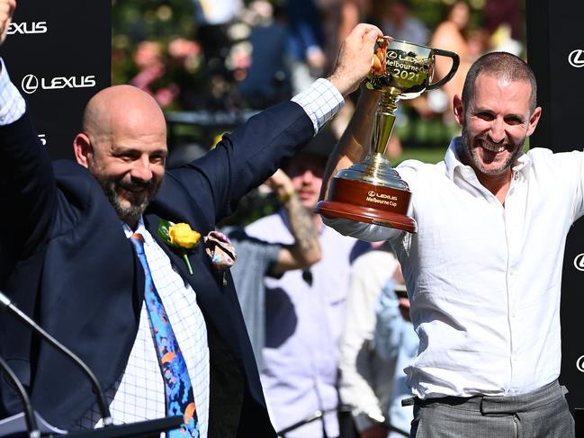 MELBOURNE, AUSTRALIA - NOVEMBER 02: Verry Elleegant owners Brae Sokolski and Ozzie Kheir celebrate with the Lexus Melbourne Cup after James Mcdonald rode #4 Verry Elleegant to victory in race 7, the Lexus Melbourne Cup during 2021 Melbourne Cup Day at Flemington Racecourse on November 02, 2021 in Melbourne, Australia. (Photo by Quinn Rooney/Getty Images)