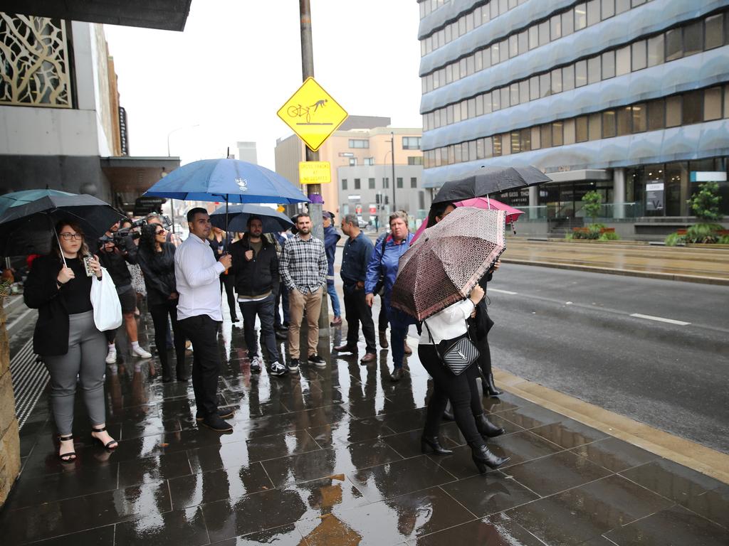 Family and friends wait to shield Jarryd Hayne as he arrives at Newcastle Court for sentencing. Picture: NCA NewsWire / Peter Lorimer.