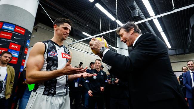 MELBOURNE, AUSTRALIA - JULY 07: Collingwood President Jeff Browne presents the match ball to Scott Pendlebury of the Magpies after he broke the league record for the most possessions during the 2023 AFL Round 17 match between the Western Bulldogs and the Collingwood Magpies at Marvel Stadium on July 7, 2023 in Melbourne, Australia. (Photo by Dylan Burns/AFL Photos via Getty Images)