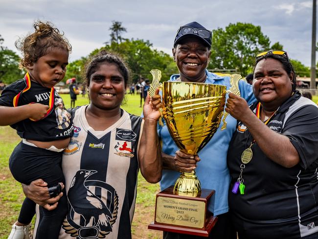 2024 Indigenous Round Honouree Mary Dunn presenting the Mary Dunn Cup to the 2023 Tiwi Islands Football League women's premiers Muluwurri Magpies (December 2023). Picture: Patch Clapp / AFLNT Media