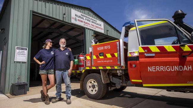 Ron Threlfall and daughter Skye at the Nerrigundah NSW Rural Fire Service shed, above; the scene when survivors emerged from the Nerrigundah fire shed that saved their lives. Picture: Sean Davey