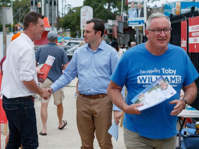 Michael Regan (left) on election day, greeting the Liberal candidate Toby Williams and former Wakehurst MP Bead Hazzard. Picture: NCA NewsWire / David Swift