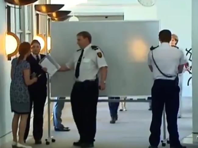 Michaelia Cash hides behind a white screen on her way to Senate estimates. Picture: Supplied/Seven