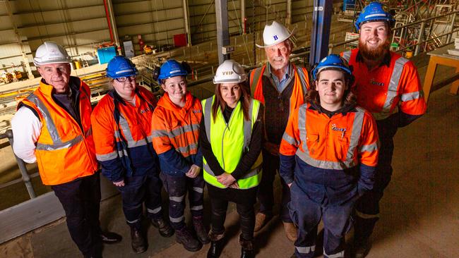 L-R: Incat Strategic Adviser Peter Gutwein, apprentices Sarah Thomson and Carys Lavia, Senator Jacqui Lambie, Incat Chairman Robert Clifford, and apprentices Joel Bresnehan and Adrian Sheldrick above Wilsons Dock at Incat, where a 130m ship is under construction. Picture: Linda Higginson