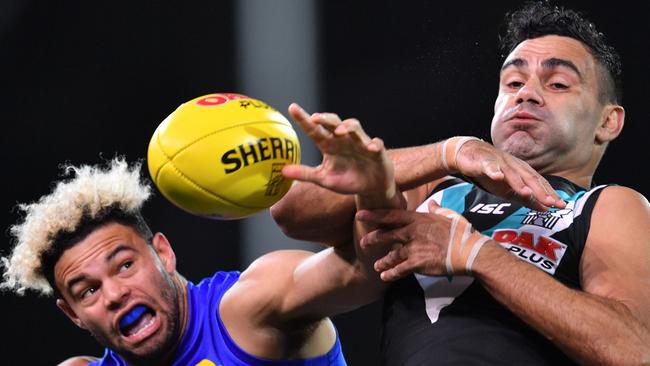 Jason Johannisen of the Bulldogs and Lindsay Thomas of the Power contest the ball during the Round 13 AFL match between the Port Adelaide Power and the Western Bulldogs at Adelaide Oval in Adelaide, Thursday, June 14, 2018. (AAP Image/David Mariuz) NO ARCHIVING, EDITORIAL USE ONLY