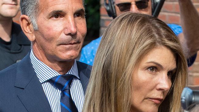 Actress Lori Loughlin (R) and husband Mossimo Giannulli exit the Boston Federal Court house after a pre-trial hearing with Magistrate Judge Kelley at the John Joseph Moakley US Courthouse in Boston on August 27, 2019. - Loughlin and Giannulli are charged with conspiracy to commit mail and wire fraud and conspiracy to commit money laundering in the college admissions scandal. (Photo by Joseph Prezioso / AFP)