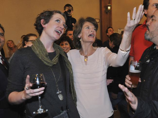 U.S. Sen. Lisa Murkowski, R-Alaska, center, watches returns with supporters Leila Kimbrell, left,and Jason Harmon in Anchorage Alaska, Tuesday, Nov. 8, 2016. (AP Photo/Michael DInneen)