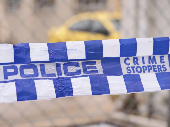 Blue and white Police tape cordoning off a area with a yellow car at a industrial area, Australia 2016 Police tape cordoning off a area with a yellow car - Stock image ipad generic