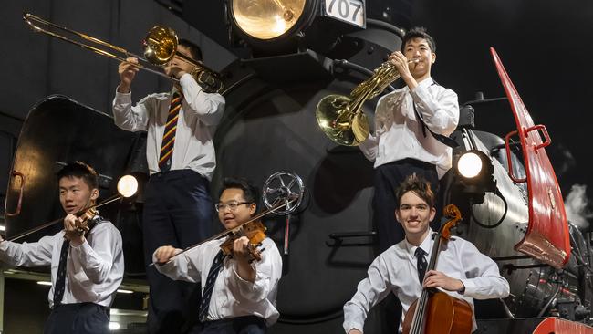 Melbourne Grammar Symphony Orchestra students Daniel Bian, Nicholas Lew, Darius Goh, Jonathan Tong and Lachlan Bushby, are ready to ride the train to country Victoria to perform in 10 regional communities.