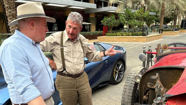 Warren speaks to a passer by who is admiring the roadster.