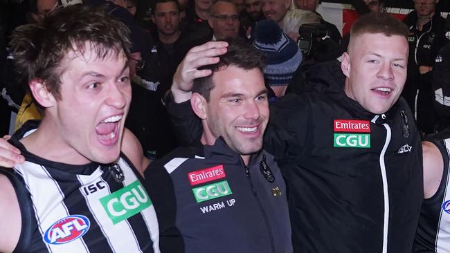 Darcy Moore, Levi Greenwood and Jordan De Goey celebrate Collingwood’s qualifying final win.