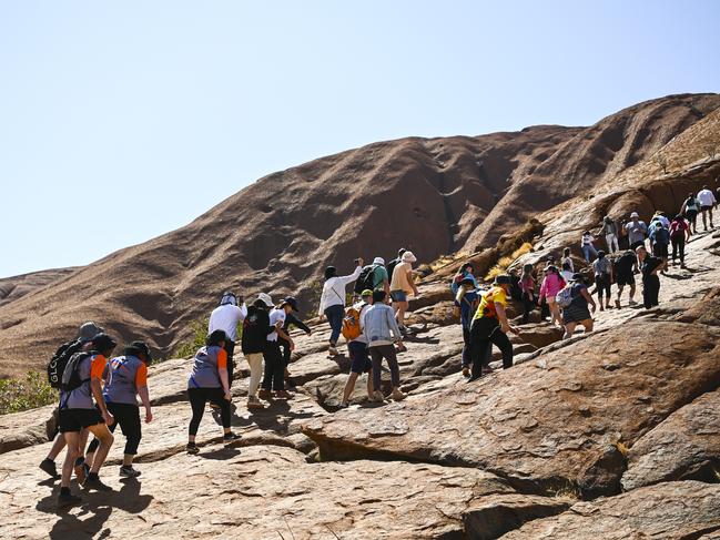 Tourists are seen climbing Uluru, also known as Ayers Rock at Uluru-Kata Tjuta National Park in the Northern Territory on the last day. Picture: AAP