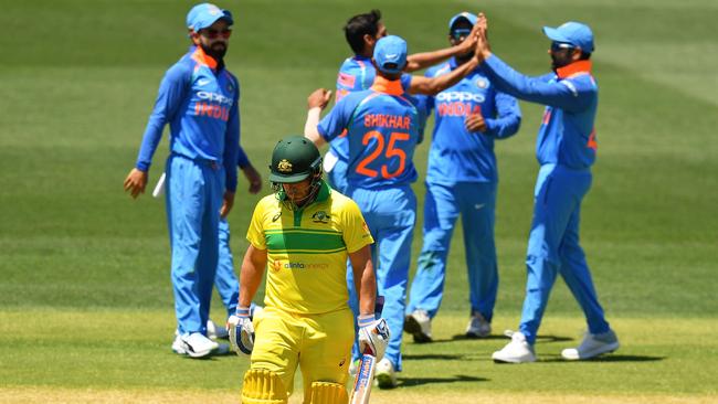 Aaron Finch walks while India celebrate. (Photo by Daniel Kalisz/Getty Images)