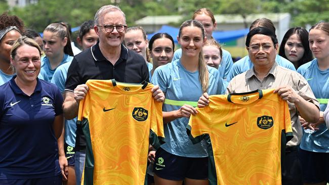 Prime Minister Anthony Albanese and Vietnam's Prime Minister Pham Minh Chinh each hold a jersey of the Australian national women’s under-20 team at the United Nations International School in Hanoi. Picture: Nhac Nguyen/AFP