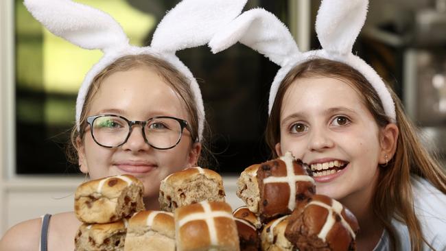 Zoe (left) and Nicola with Coles Hot Cross Buns. Picture: Martin Keep/Coles