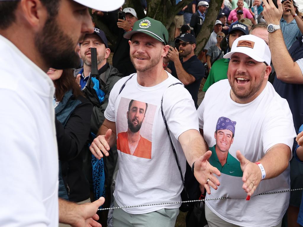 Scheffler shakes hands with fans wearing Scheffler t-shirts as he walks off the ninth green. Picture: Patrick Smith/Getty Images