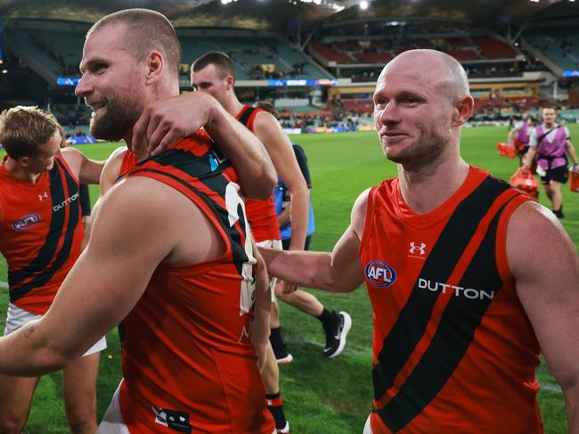 ADELAIDE, AUSTRALIA - APRIL 19: Jake Stringer and Nick Hind of the Bombers celebrate their win during the 2024 AFL Round 06 match between the Adelaide Crows and the Essendon Bombers at Adelaide Oval on April 19, 2024 in Adelaide, Australia. (Photo by James Elsby/AFL Photos via Getty Images)