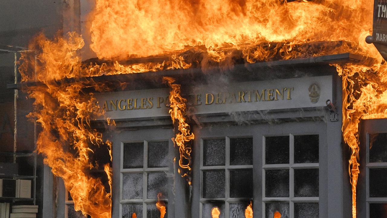 A Los Angeles Police Department kiosk was set ablaze in a riot. Picture: AP Photo/Mark J. Terrill