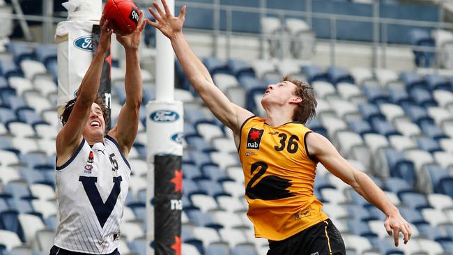 Vic Country’s Aaron Cadman outmarks Western Australia’s Jed Adams. Picture: Dylan Burns/AFL Photos via Getty Images