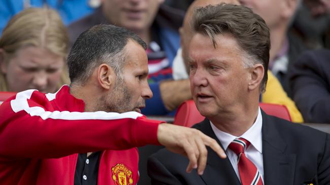 Manchester United's manager Louis van Gaal chats with his assistant Ryan Giggs.