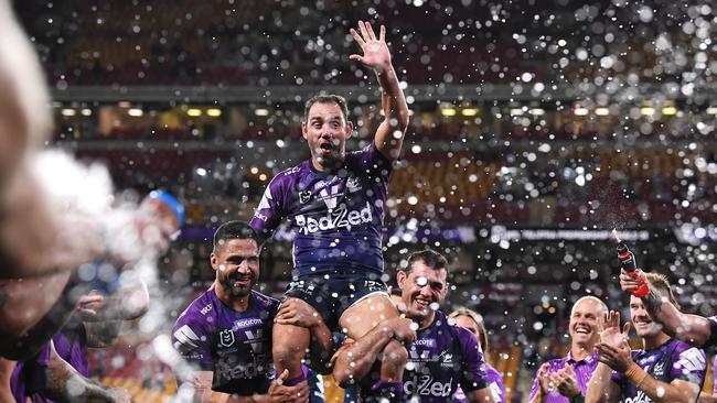 Storm captain Cameron Smith is chaired off Suncorp Stadium last Friday night with his teammates predicting the end of his career is imminent. Picture: Getty Images