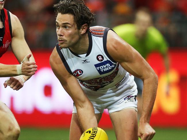 Giants Josh Kelly handballs against Essendon.