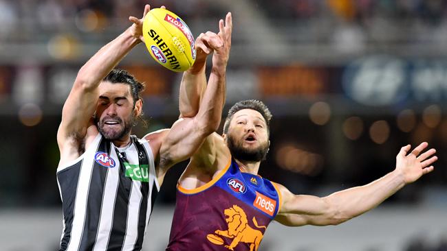 Brodie Grundy wins a hit out against Brisbane Lions opponent Stefan Martin. Picture: AAP Image/Darren England.