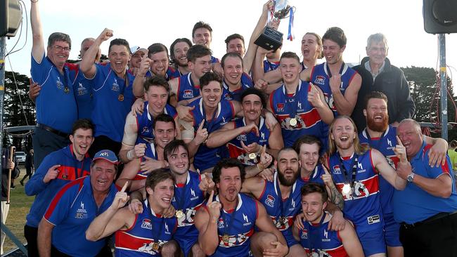 St Paul's players raise the premiership cup after defeating East Malvern.