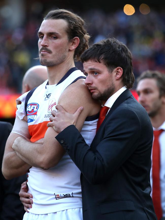 Dylan Buckley consoles GWS skipper Phil Davis after this year’s Grand Final. Picture. Phil Hillyard