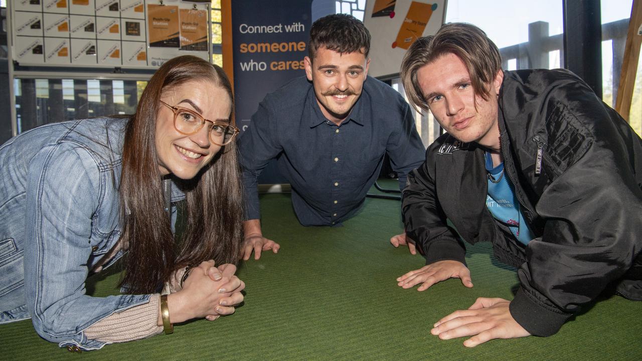 (From left) Renee O'Sullivan (teacher), Alex Thompson-Welch (IT) and Zane Clohesy (year 11) take part in the Push-Up Challenge at Toowoomba Flexi School. Tuesday, June 1, 2021. Picture: Nev Madsen.