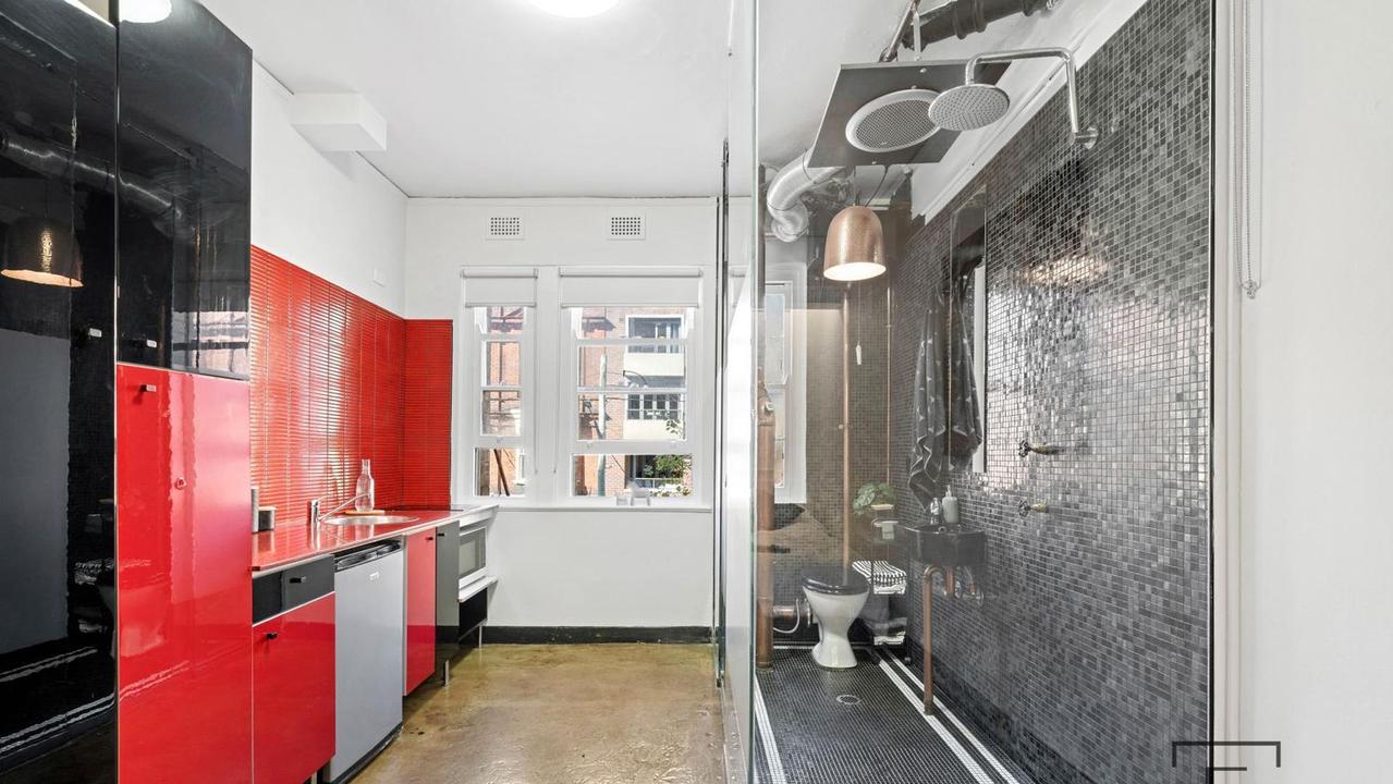 Only semi-frosted glass separates the toilet from the stove.