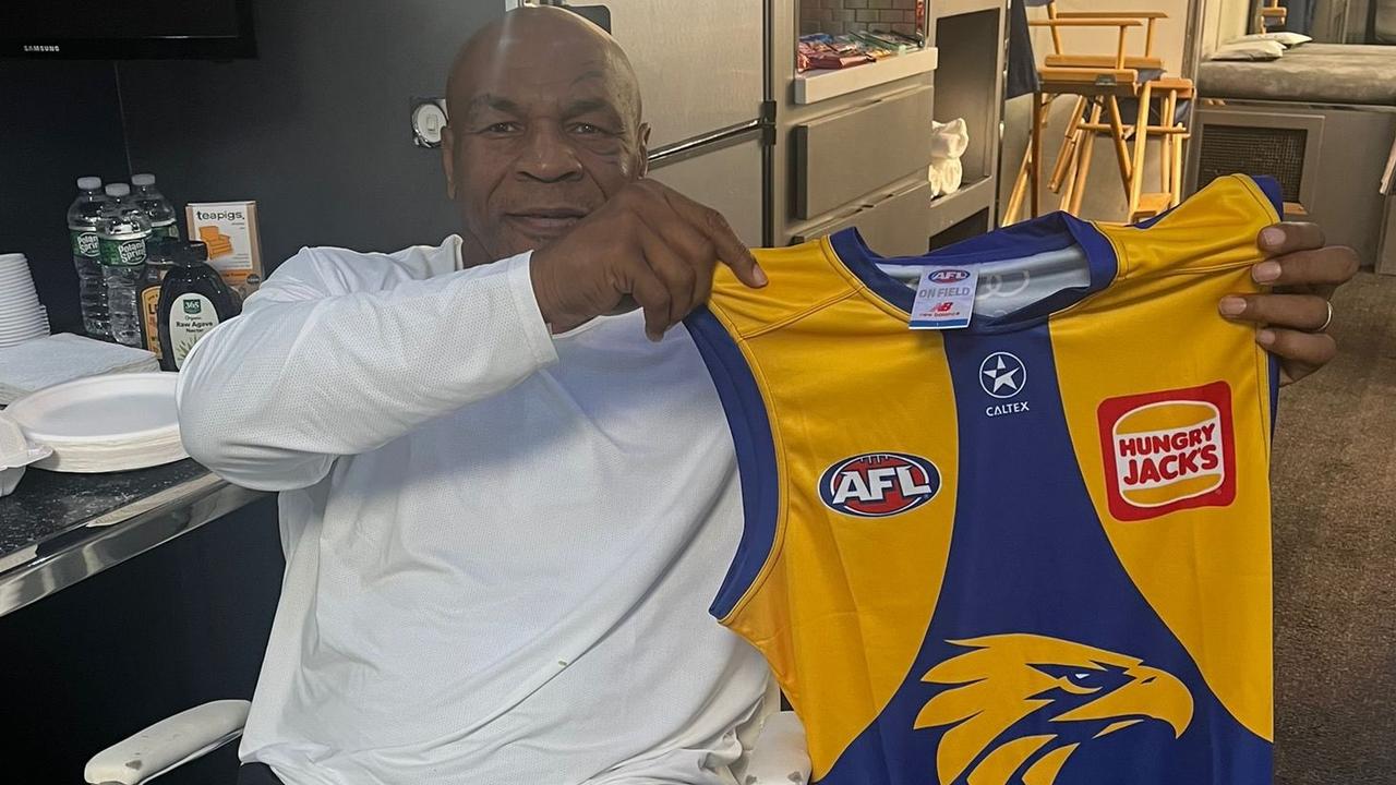 Mike Tyson holding a West Coast Eagles jumper