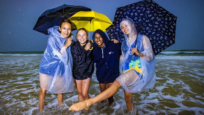 Marija Butautyte, 14, Isabella Ruthven, 14, Shalomi Samuel, 13 and Eva Gordienko, 14 from Melbourne during a rainy day at Coolangatta. Picture: Nigel Hallett