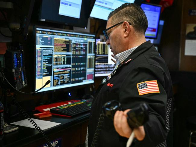 Traders and financial professionals work on the floor of the New York Stock Exchange (NYSE) at the opening bell on January 27, 2025 in New York City. European and Asian stock markets mostly slid Monday and Wall Street was forecast to open sharply lower on talk that a cheaper Chinese generative AI programme can outperform big-name rivals, notably in the United States. (Photo by ANGELA WEISS / AFP)