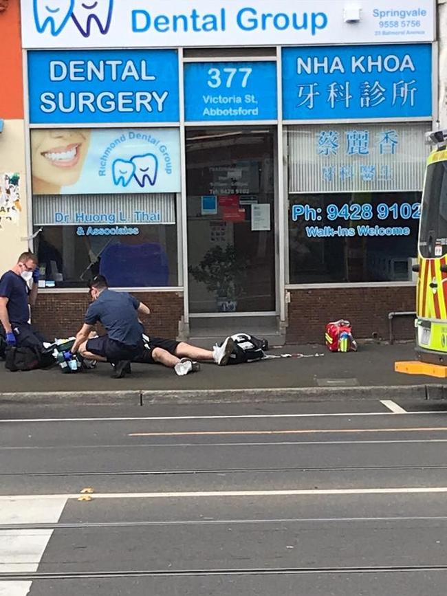 Paramedics treat a person on bustling Victoria St. Picture: Supplied