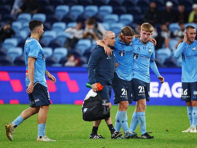 SYDNEY, AUSTRALIA - MAY 04: Luke Brattan of Sydney FC is guided off the field due to injury during the A-League Men Elimination Final match between Sydney FC and Macarthur FC at Allianz Stadium, on May 04, 2024, in Sydney, Australia. (Photo by Jeremy Ng/Getty Images)