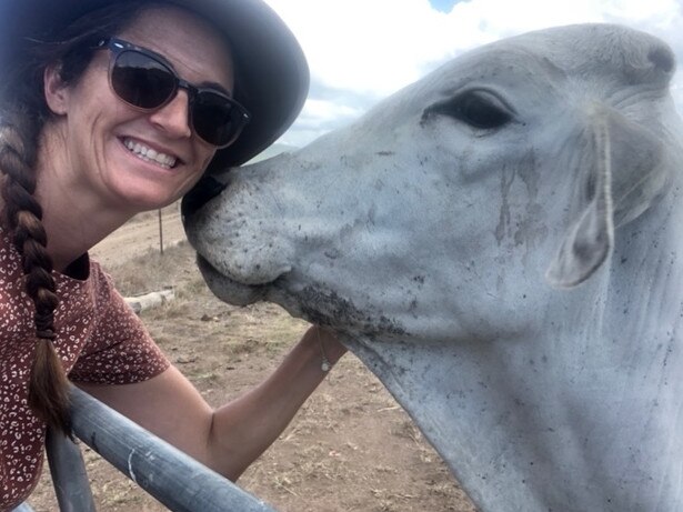 Amie Bolton getting friendly with the cows during her visit to Oh Deeres Farm Stay at Calen. Picture: Contributed