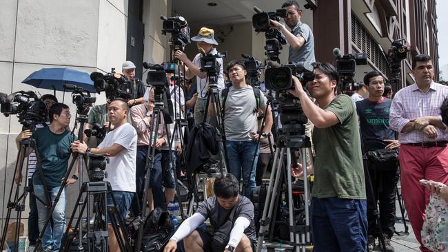 Media wait at the entrance of the St Regis Hotel ahead of Kim Jong-un’s arrival. Picture: Getty Images.