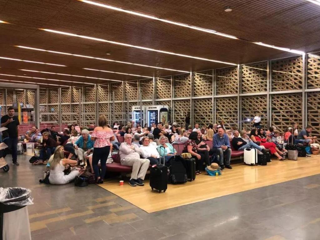 Passengers wait for a new plane to continue their journey.