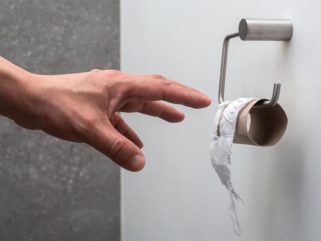 A hand reaching for an empty toilet paper holder (concept toilet paper finished)  Picture: istock