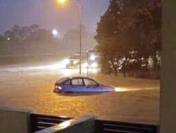 A car stranded in flood water at Pimpama during Monday night's massive downpour. Picture: Mandy Hamer.