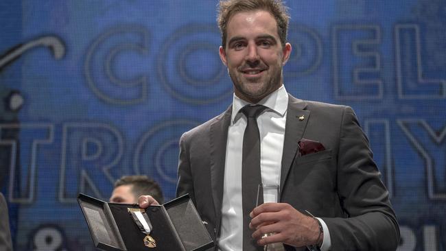 Steele Sidebottom is all smiles with the Copeland Trophy, awarded for Collingwood’s best and fairest. Picture: AAP