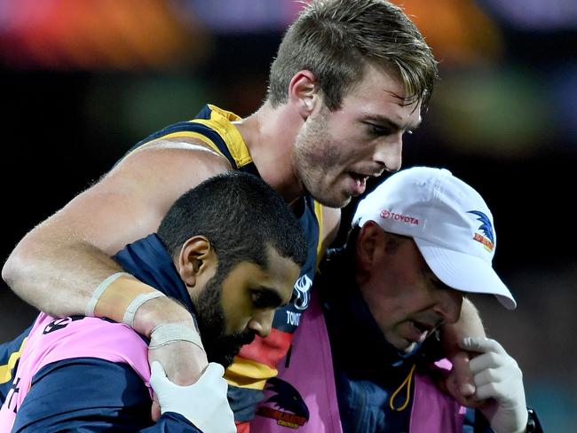 ADELAIDE, AUSTRALIA - AUGUST 18:  Daniel Talia of the Crows is helped off by  crows trainers during the round 22 AFL match between the Adelaide Crows and the Sydney Swans at Adelaide Oval on August 18, 2017 in Adelaide, Australia.  (Photo by Mark Brake/Getty Images)