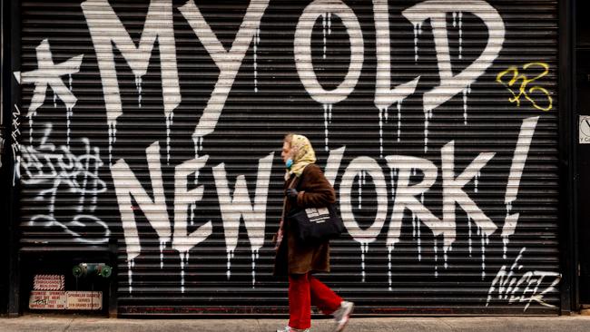 A person walks past a closed business in New York City. New York State Governor Andrew Cuomo says New York State remains ‘on pause’ and has extended lockdowns until May 15. Picture: David Dee Delgado/Getty/AFP