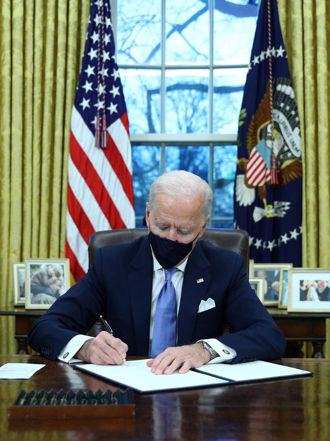 U.S. President Joe Biden signs executive orders in the Oval Office after his inauguration. Picture: Reuters/Tom Brenner