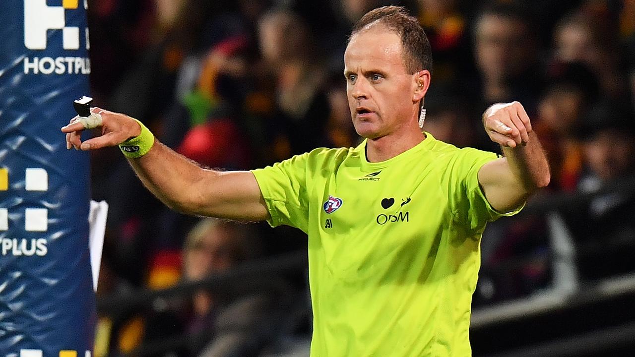 An umpire calls for a score review during an AFL match. (Photo by Daniel Kalisz/Getty Images)