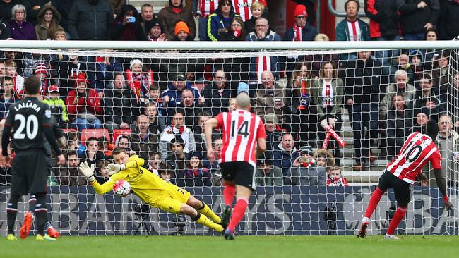 Simon Mignolet of Liverpool saves a penalty.