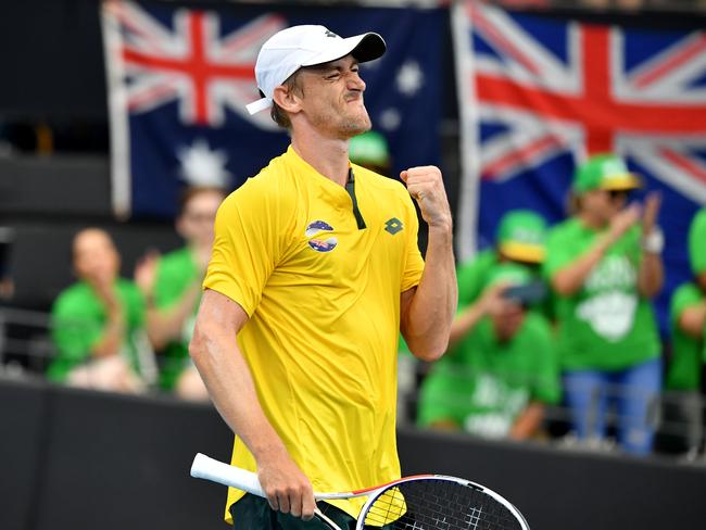 Brisbane-bred John Millman celebrates has win over Felix Auger-Aliassime of Canada on day three of the ATP Cup tennis tournament at Pat Rafter Arena yesterday. Picture: Darren England/AAP