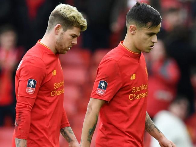 Liverpool's Spanish defender Alberto Moreno (L) and Liverpool's Brazilian midfielder Philippe Coutinho leave the pitch following the English FA Cup fourth round football match between Liverpool and Wolverhampton Wanderers at Anfield in Liverpool, north west England on January 28, 2017. Wolverhampton won the match 2-1. / AFP PHOTO / Paul ELLIS / RESTRICTED TO EDITORIAL USE. No use with unauthorized audio, video, data, fixture lists, club/league logos or 'live' services. Online in-match use limited to 75 images, no video emulation. No use in betting, games or single club/league/player publications. /