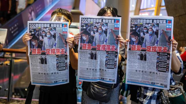 Jimmy Lai supporters hold issues of Apple Daily as they protest for press freedom inside a mall in Hong Kong in August. Picture: AFP